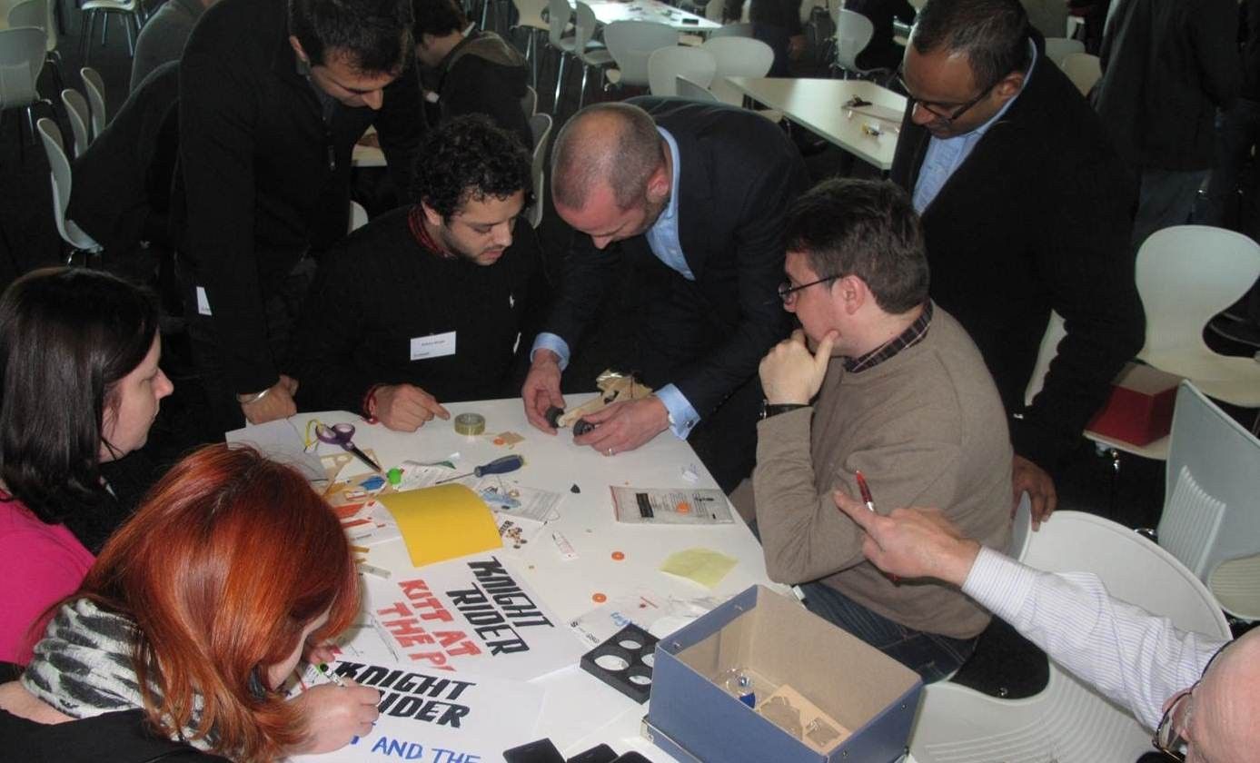 A team collaborating around the build table mid-sprint