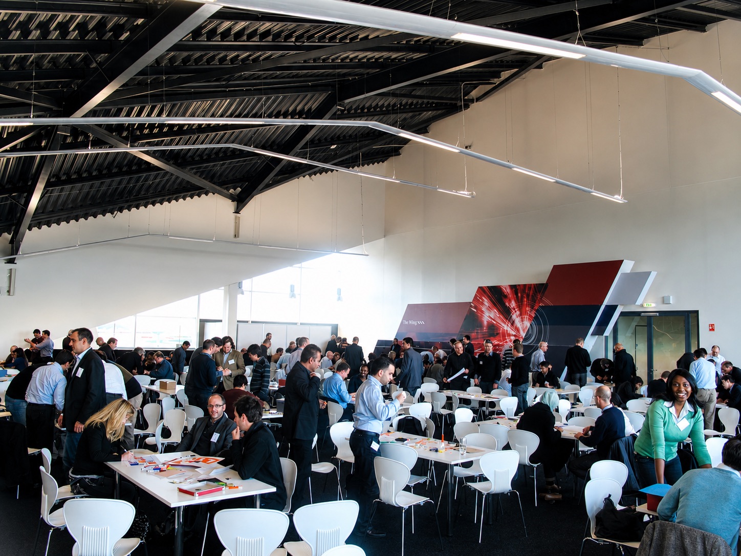 A full room of teams at work during a Business of Racing corporate event